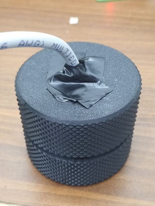 The closed, light-tight enclosure. Only the signal cable leaves the housing.