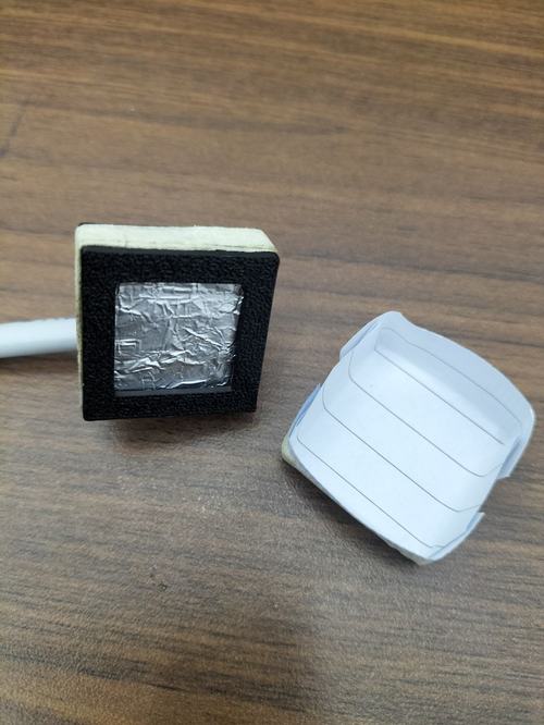 The paper shield: a simple folded paper cap (right) that fits over the detector's foil window (left).